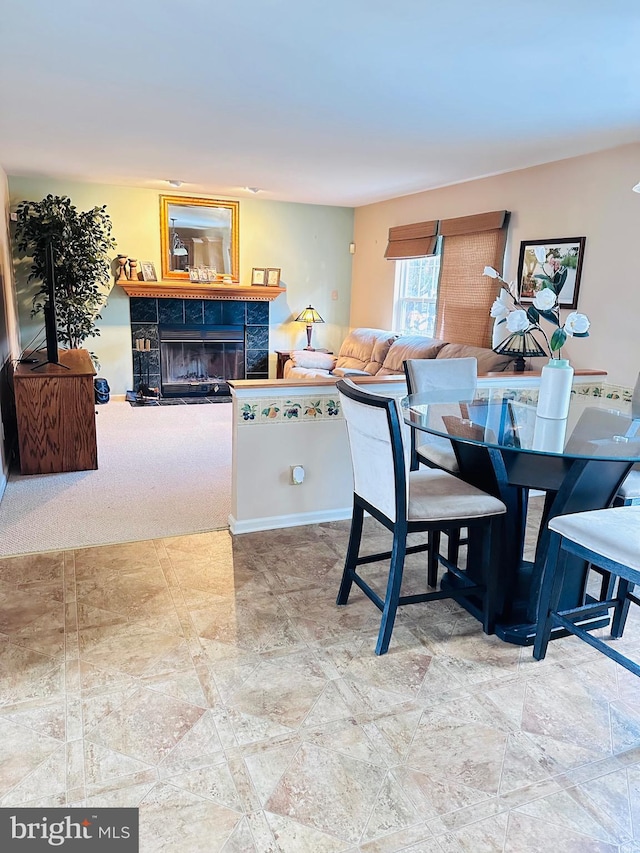 dining area featuring a tiled fireplace