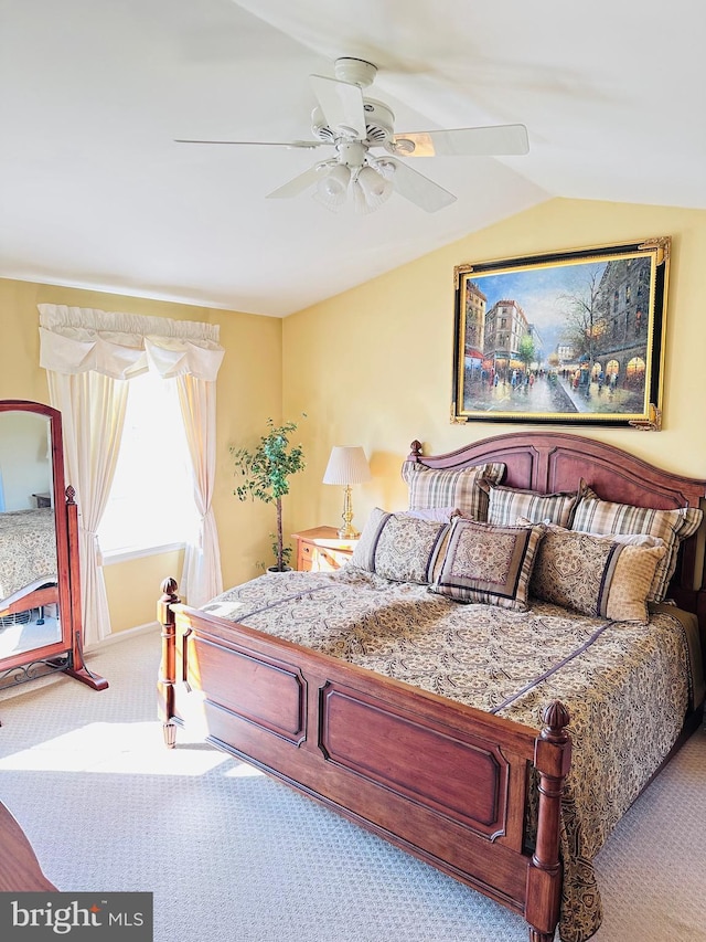 bedroom featuring lofted ceiling, ceiling fan, and carpet flooring