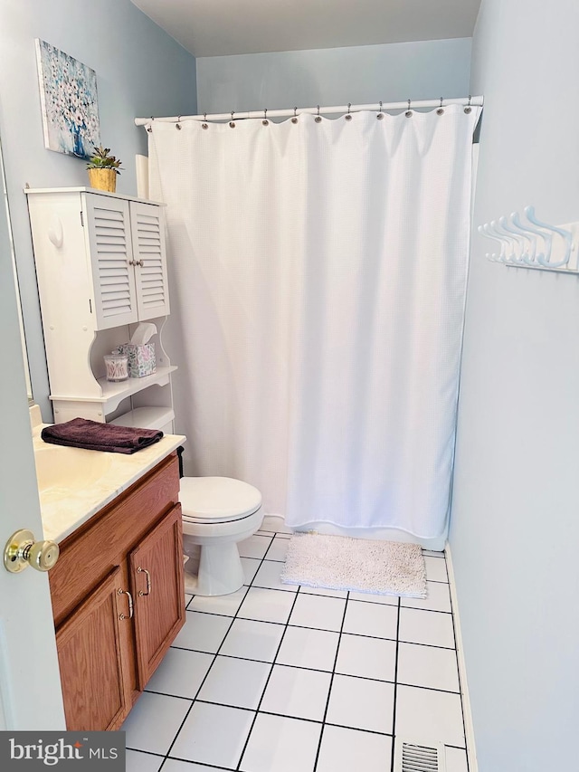 full bathroom with tile patterned flooring, a shower with curtain, toilet, and vanity