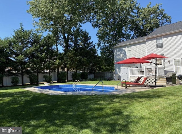 view of swimming pool featuring a lawn, a fenced backyard, a fenced in pool, and a wooden deck