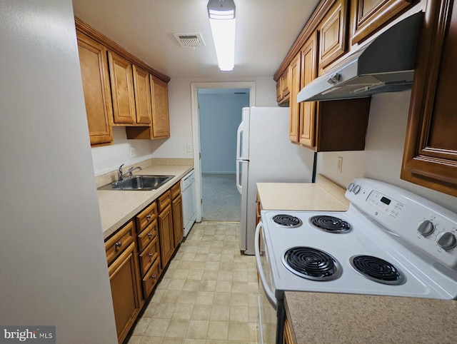 kitchen featuring visible vents, under cabinet range hood, light countertops, white appliances, and a sink