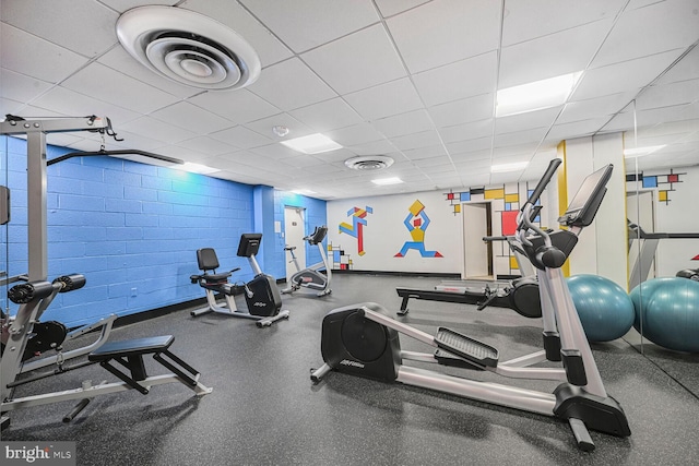 gym featuring a drop ceiling and visible vents