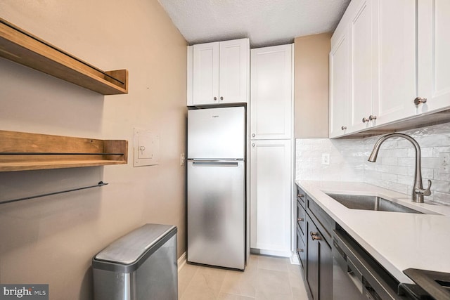 kitchen with white cabinetry, appliances with stainless steel finishes, and a sink