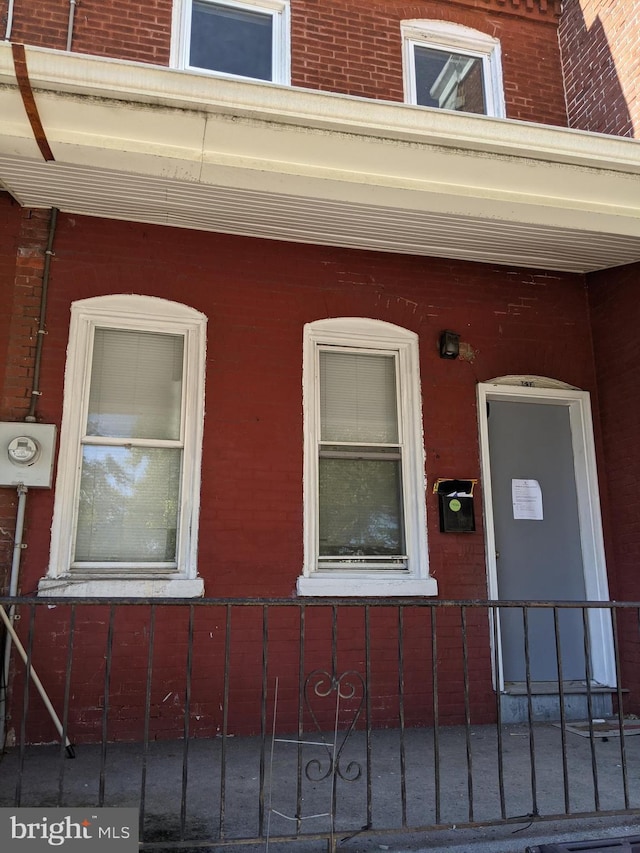 property entrance with brick siding