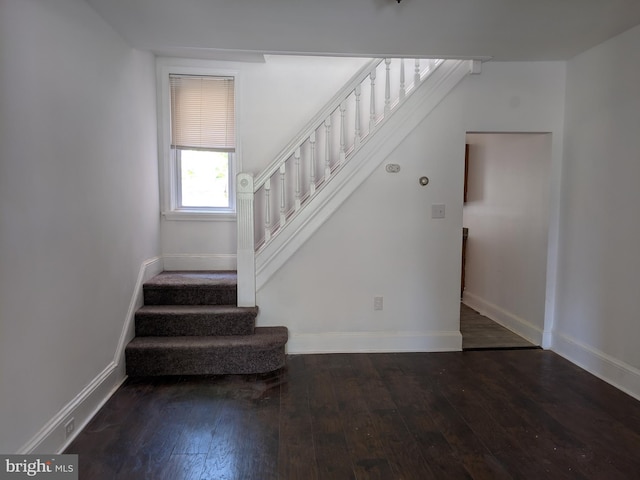 staircase with baseboards and hardwood / wood-style flooring