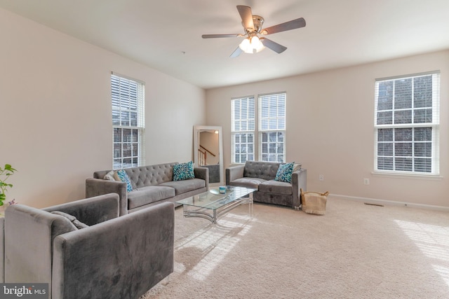 living area with baseboards, carpet, and ceiling fan