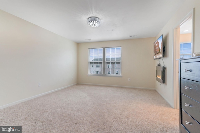 interior space with visible vents, baseboards, and carpet