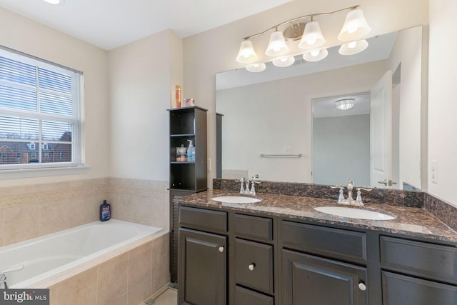 bathroom with double vanity, a garden tub, and a sink