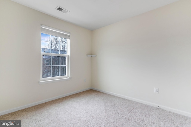 carpeted spare room with baseboards and visible vents