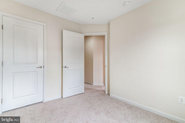 unfurnished bedroom featuring carpet flooring, baseboards, and visible vents