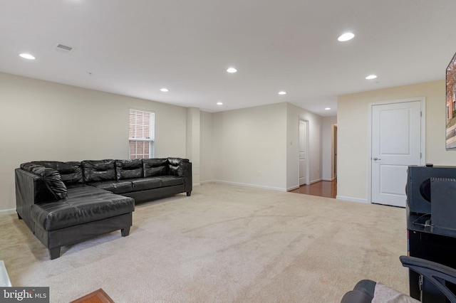 living room with light carpet, visible vents, recessed lighting, and baseboards