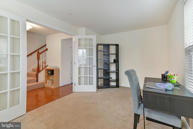 carpeted home office featuring french doors