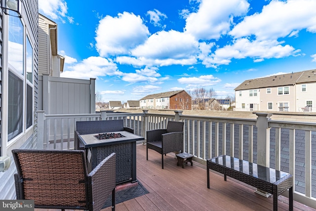 deck featuring a fire pit and a residential view