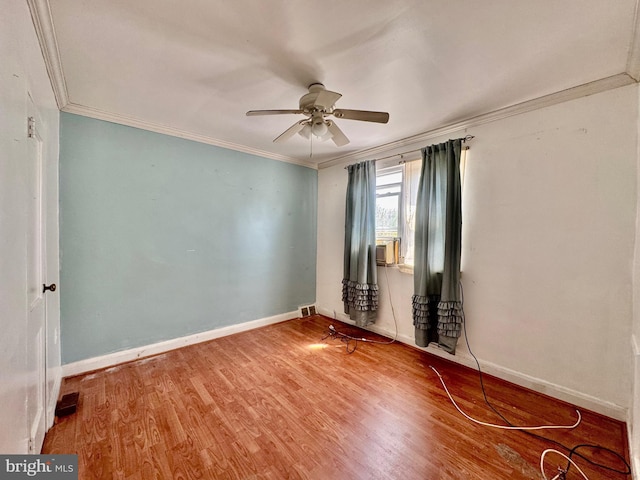 unfurnished room with ornamental molding, baseboards, a ceiling fan, and wood finished floors