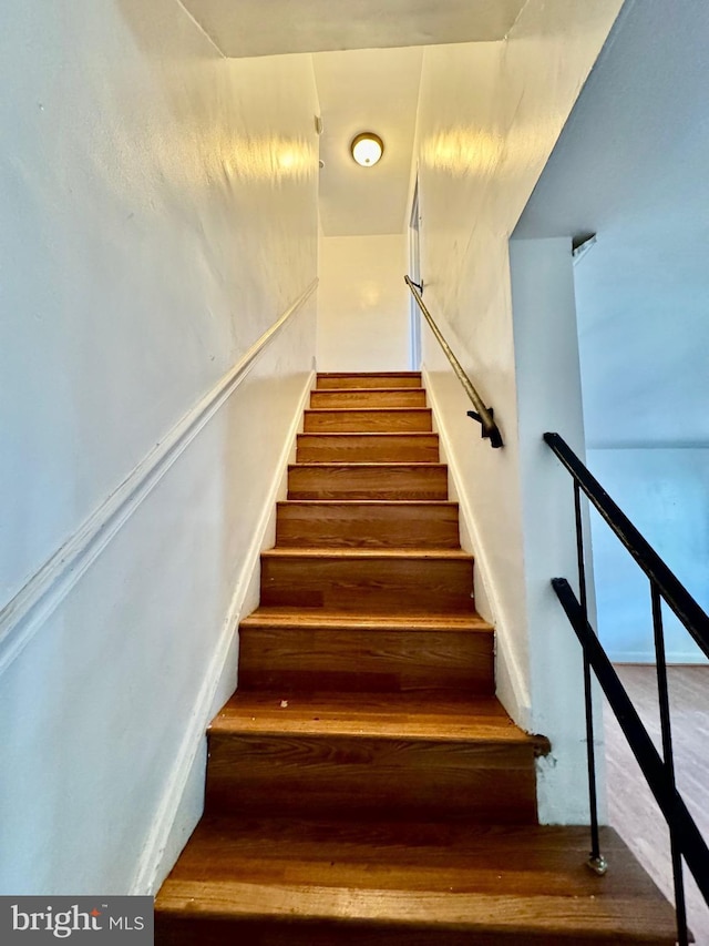 stairs with wood finished floors