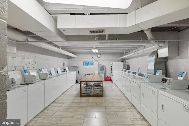 shared laundry area featuring visible vents and washing machine and dryer