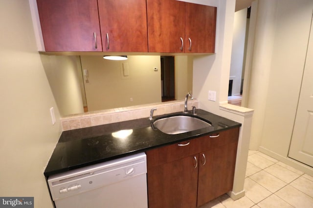 kitchen with a sink, dishwasher, and light tile patterned floors