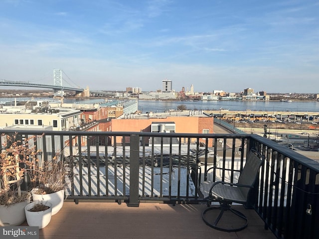 balcony featuring a city view and a water view