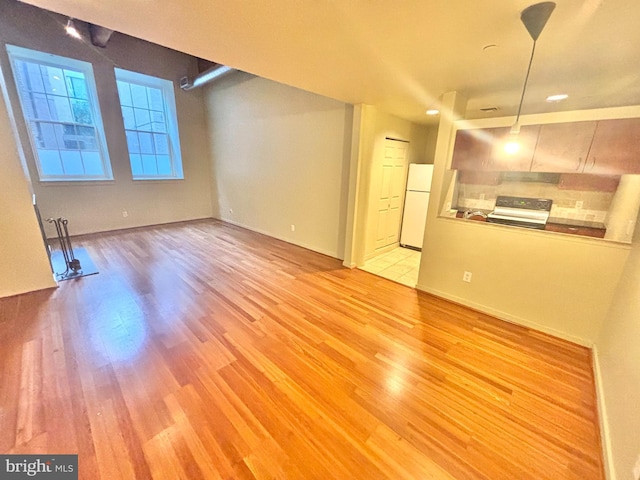 unfurnished living room with light wood-type flooring