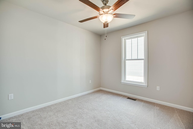 unfurnished room featuring visible vents, baseboards, a ceiling fan, and carpet flooring