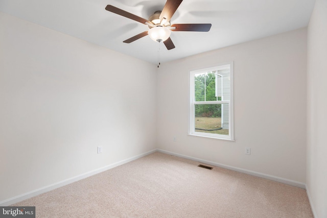 unfurnished room featuring carpet flooring, visible vents, baseboards, and ceiling fan