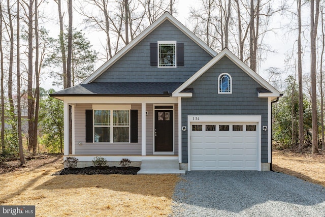 view of front of home featuring a garage, driveway, and a shingled roof