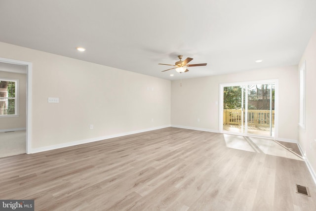 unfurnished room with a ceiling fan, visible vents, baseboards, recessed lighting, and light wood-style floors