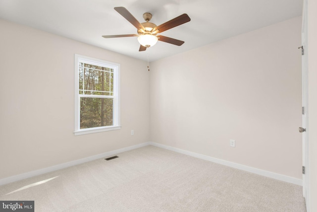 unfurnished room featuring visible vents, baseboards, ceiling fan, and carpet floors