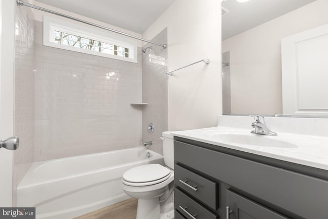 bathroom with vanity, toilet, shower / tub combination, and wood finished floors