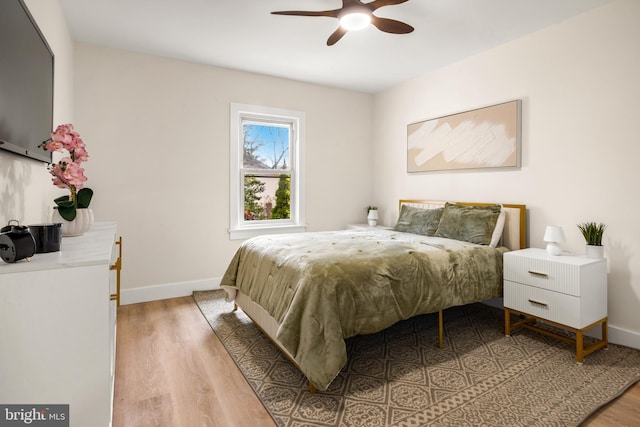 bedroom with baseboards and light wood finished floors