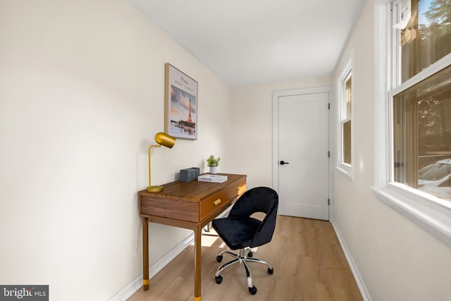 office area featuring light wood-style flooring and baseboards