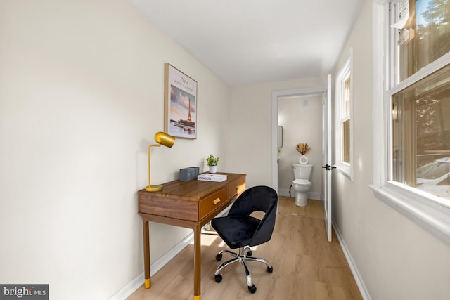 office area with light wood-type flooring and baseboards