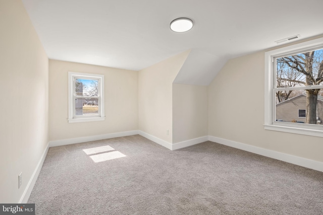 bonus room with visible vents, carpet, baseboards, and vaulted ceiling