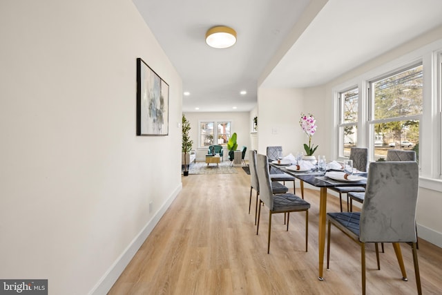 dining area featuring recessed lighting, baseboards, and light wood-type flooring