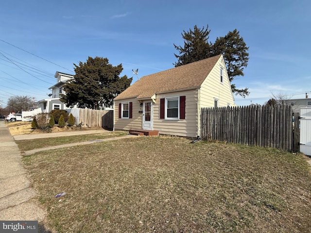 bungalow with fence and roof with shingles