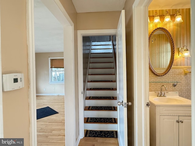 stairs featuring baseboards and wood finished floors