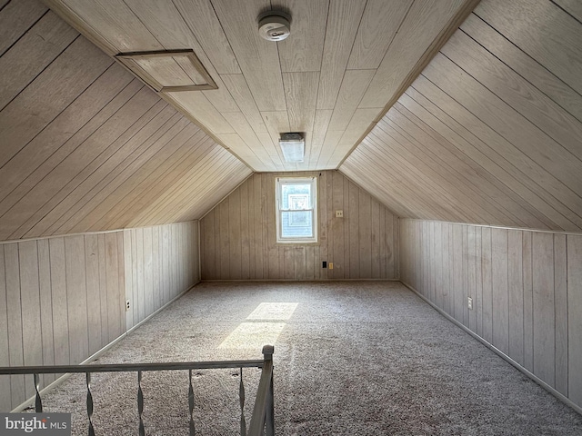 bonus room with wooden walls, wood ceiling, carpet flooring, and vaulted ceiling