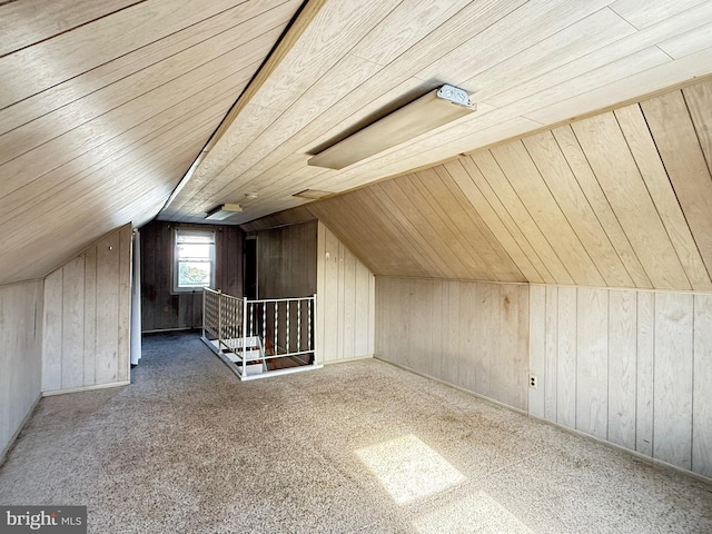 bonus room with carpet flooring, lofted ceiling, wood walls, and wooden ceiling