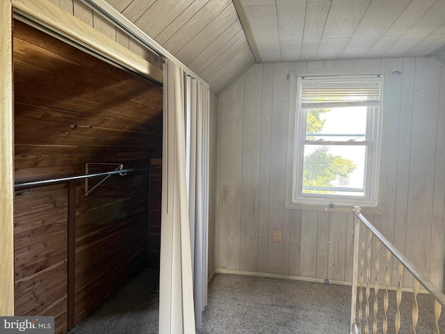 additional living space with lofted ceiling, wooden walls, carpet flooring, and wood ceiling