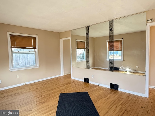 interior space with baseboards and wood finished floors