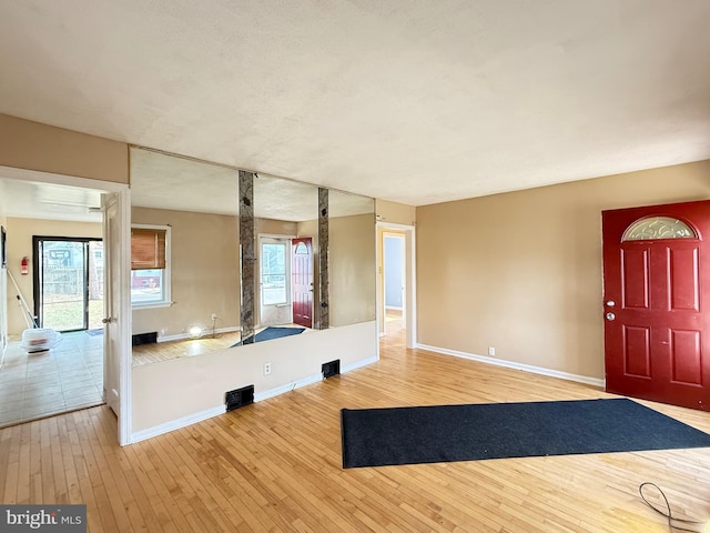 interior space with baseboards and hardwood / wood-style floors