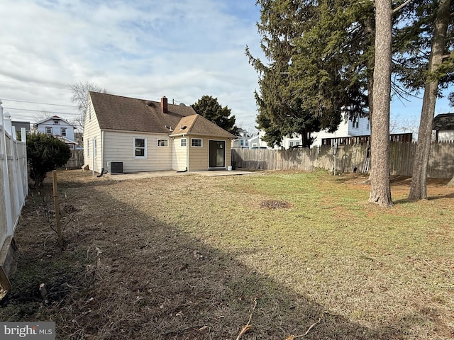 view of yard with a patio, cooling unit, and a fenced backyard