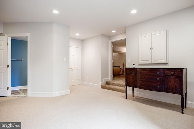 interior space featuring recessed lighting, baseboards, and carpet