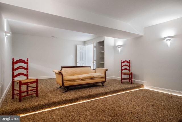 sitting room featuring built in features, visible vents, baseboards, and carpet flooring