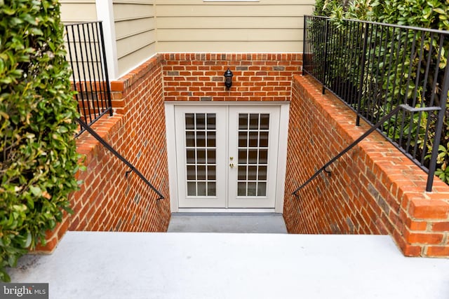 property entrance with french doors and brick siding