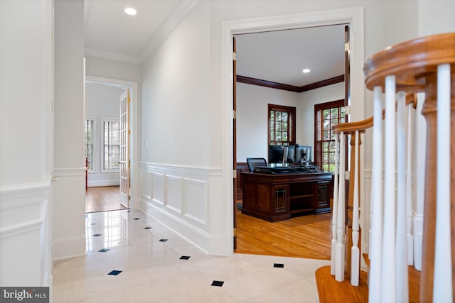 hallway with recessed lighting, a decorative wall, wainscoting, and crown molding