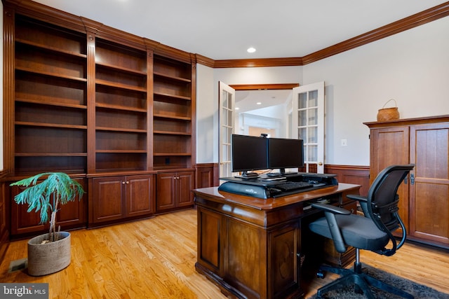 office space featuring visible vents, wainscoting, crown molding, and light wood-type flooring