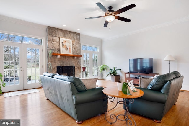 living area with ornamental molding, french doors, a ceiling fan, and wood finished floors