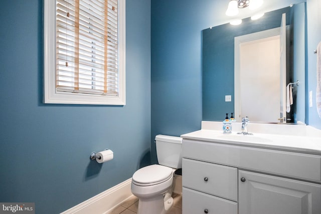 bathroom featuring tile patterned floors, toilet, vanity, and baseboards