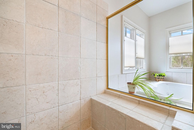 full bath with a tub with jets and a wealth of natural light